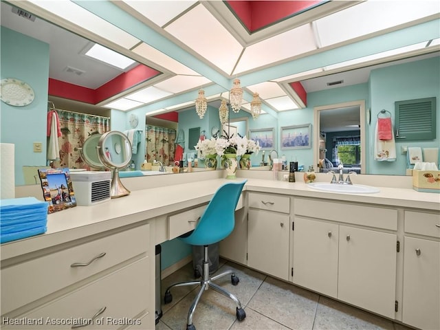 bathroom with tile patterned floors and vanity