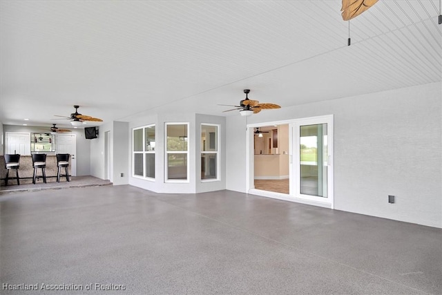 unfurnished living room featuring ceiling fan