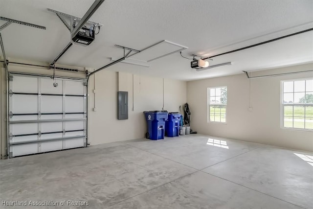 garage featuring electric panel and a garage door opener