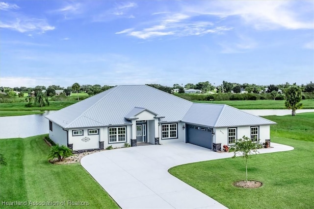 view of front of home with a garage and a front lawn