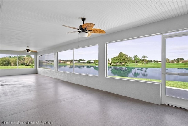 unfurnished sunroom featuring a water view and ceiling fan