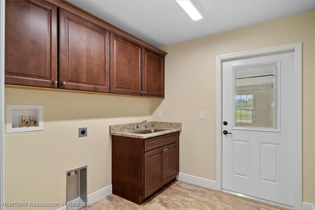 washroom with washer hookup, sink, cabinets, and hookup for an electric dryer