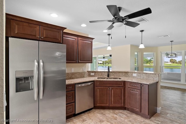 kitchen featuring appliances with stainless steel finishes, ceiling fan, pendant lighting, and sink