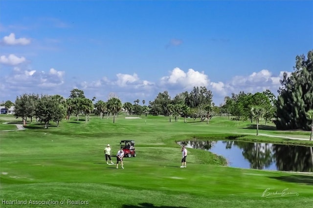 surrounding community with a yard and a water view