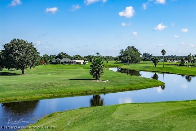 view of property's community featuring a yard and a water view