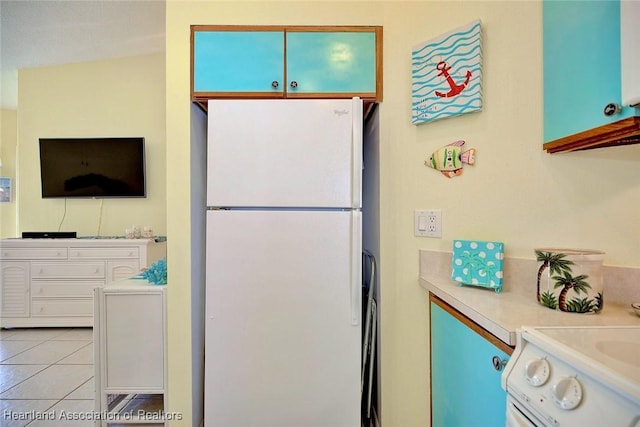 kitchen featuring white fridge and light tile patterned flooring