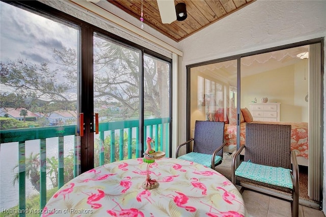 bedroom with access to exterior, lofted ceiling, and wood ceiling