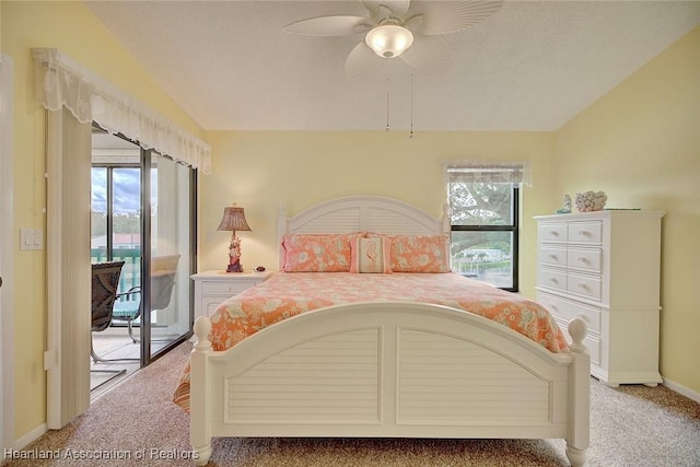 carpeted bedroom with access to exterior, a textured ceiling, vaulted ceiling, and ceiling fan