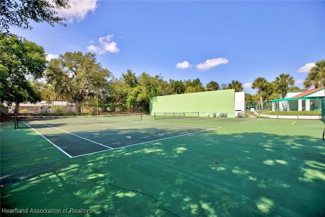 view of tennis court featuring basketball court