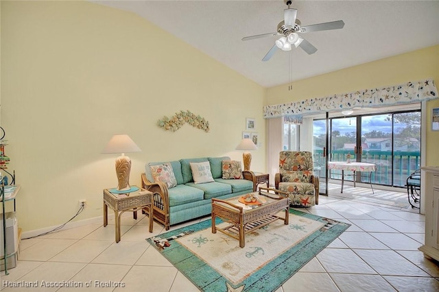 living room featuring ceiling fan, light tile patterned flooring, and vaulted ceiling