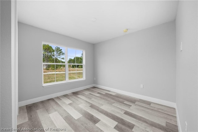 unfurnished room with light wood-type flooring