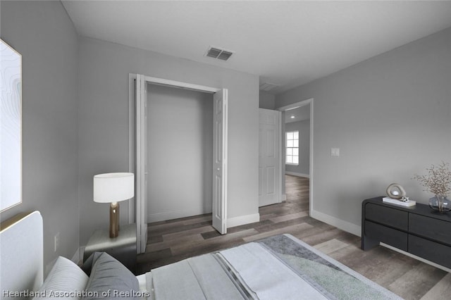 bedroom featuring dark hardwood / wood-style floors and a closet