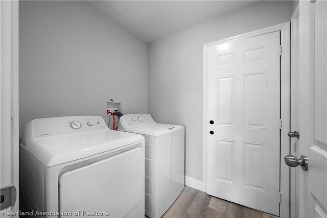 laundry area with dark hardwood / wood-style floors and independent washer and dryer