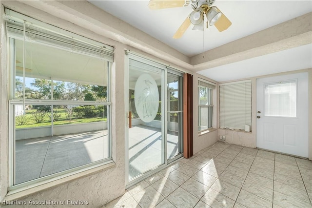 doorway featuring a wealth of natural light, a sunroom, and ceiling fan