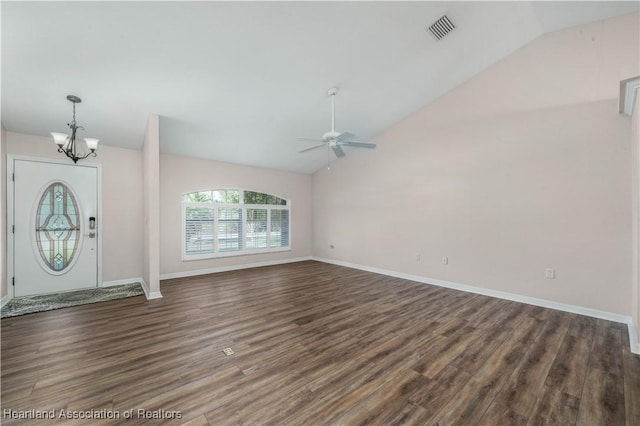 foyer with ceiling fan with notable chandelier, wood finished floors, visible vents, baseboards, and vaulted ceiling