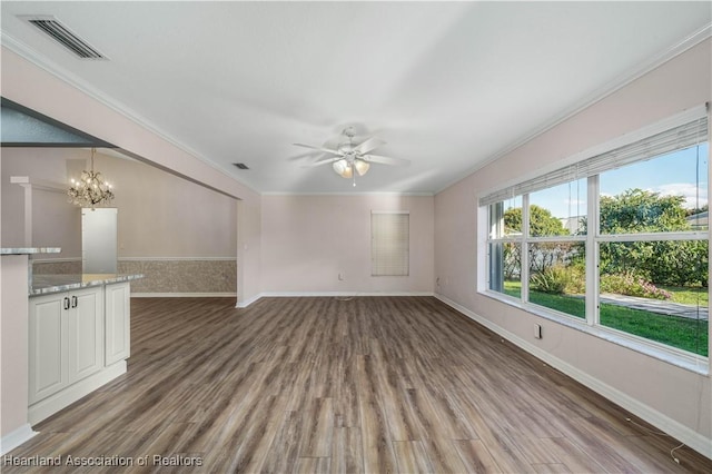 unfurnished living room featuring ornamental molding, visible vents, baseboards, and wood finished floors