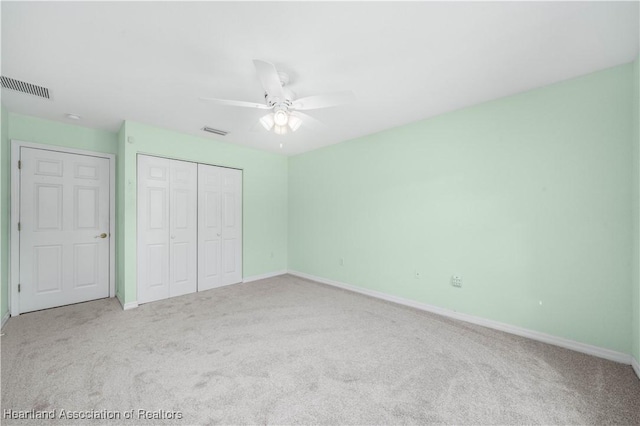 unfurnished bedroom featuring carpet, a closet, and visible vents