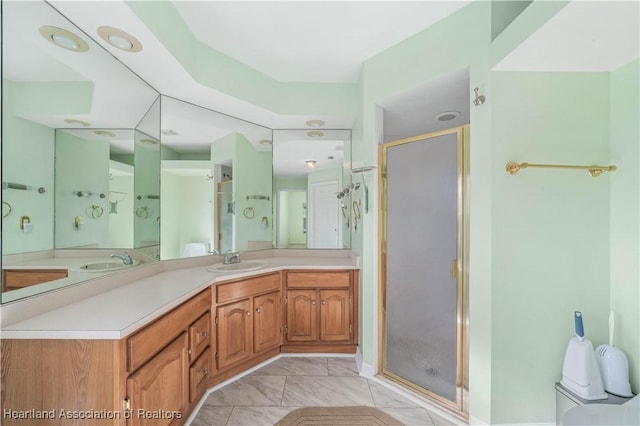 full bathroom featuring a stall shower and vanity