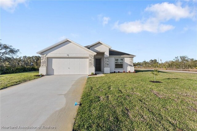 view of front of home with a front lawn, driveway, and an attached garage