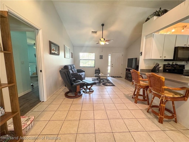 3216 Locust Ave, Lake Placid, FL 33852 - living area featuring vaulted ceiling, ceiling fan, and light tile patterned floors