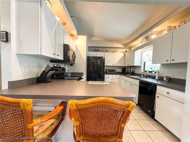 3216 Locust Ave, Lake Placid, FL 33852 - kitchen with black appliances, a peninsula, lofted ceiling, dark countertops, and a textured ceiling