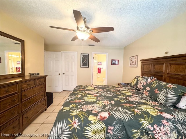3216 Locust Ave, Lake Placid, FL 33852 - bedroom featuring light tile patterned floors, a textured ceiling, ensuite bathroom, and ceiling fan