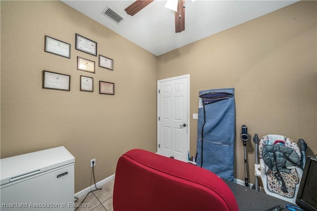 office space featuring ceiling fan and light tile patterned floors