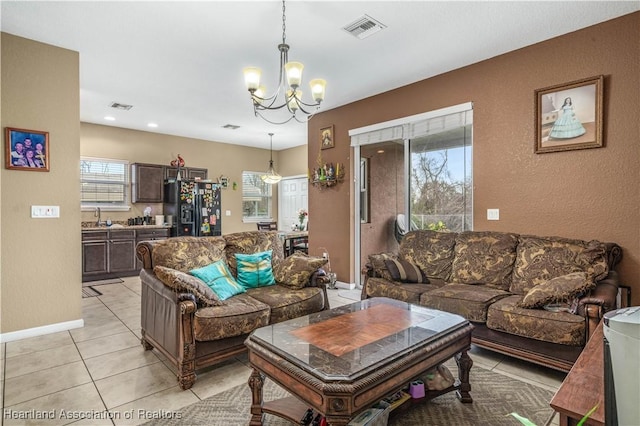 living room featuring light tile patterned floors and a chandelier