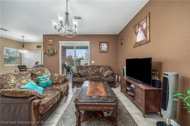 living room with light tile patterned floors and an inviting chandelier