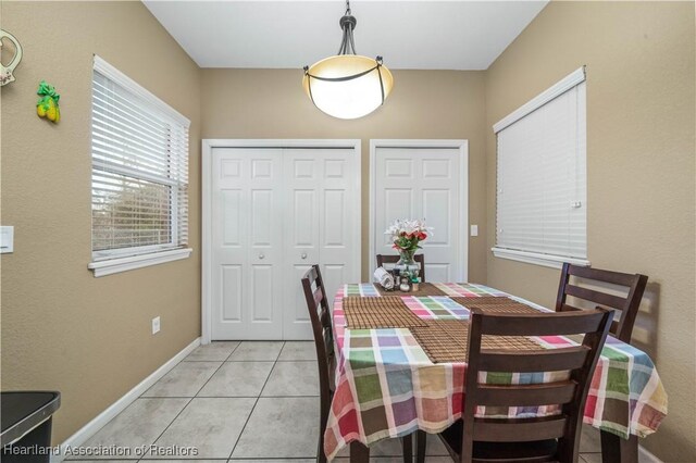 dining area with light tile patterned floors