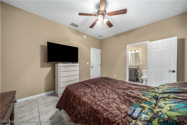 bedroom featuring light tile patterned floors, connected bathroom, and ceiling fan