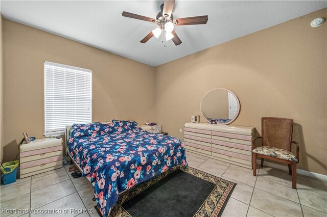 bedroom with tile patterned floors and ceiling fan