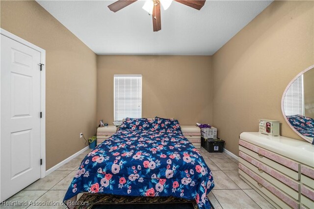 tiled bedroom with ceiling fan