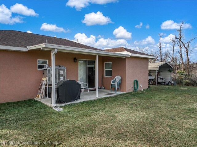 rear view of house with a yard and a patio area