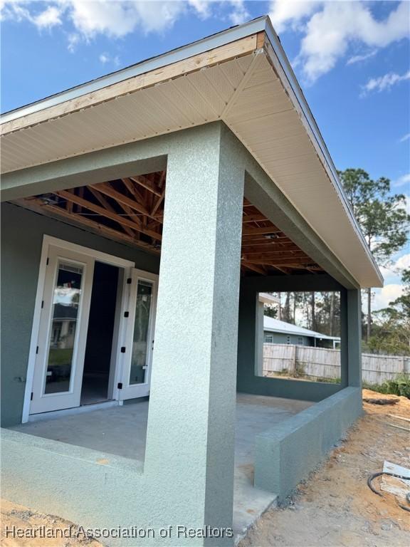 view of side of property with stucco siding