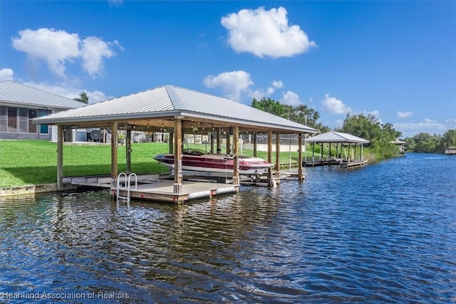 view of dock with a yard, a water view, and boat lift