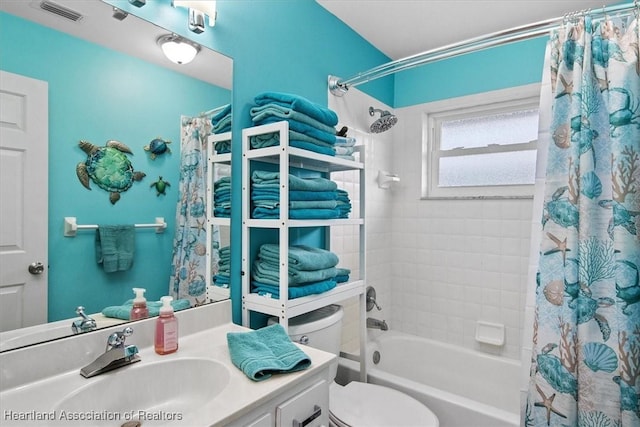 full bathroom featuring toilet, visible vents, shower / bath combo with shower curtain, and vanity