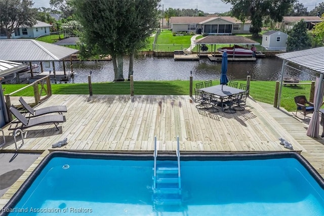 view of pool with a yard, a boat dock, a water view, and a residential view