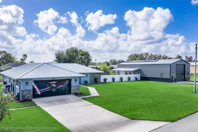 view of front of home featuring a garage, a front yard, fence, and driveway