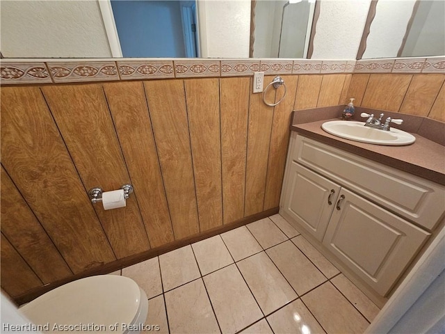 bathroom with tile patterned flooring, vanity, and toilet