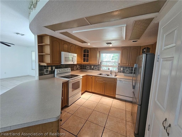 kitchen with ceiling fan, sink, light tile patterned floors, and white appliances