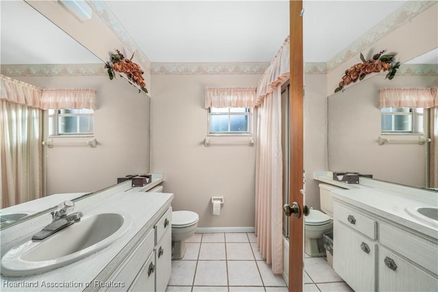 bathroom featuring tile patterned flooring, vanity, and toilet