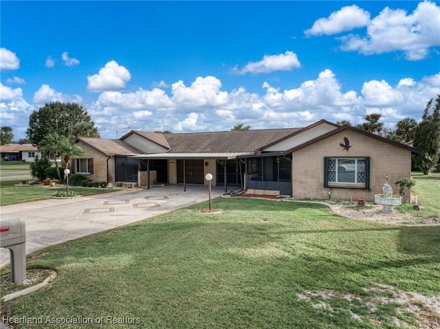 ranch-style house featuring a carport and a front lawn