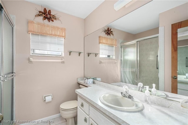 bathroom featuring vanity, toilet, a shower with shower door, and tile patterned flooring