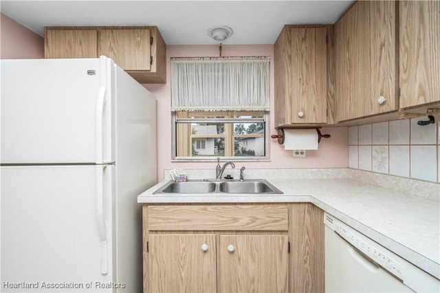 kitchen featuring white appliances and sink