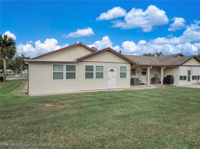 ranch-style house featuring a patio, cooling unit, and a front lawn