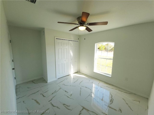 unfurnished bedroom featuring a closet and ceiling fan