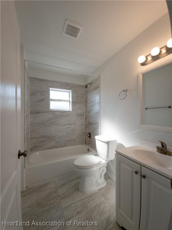 full bathroom with vanity, toilet, and tiled shower / bath combo