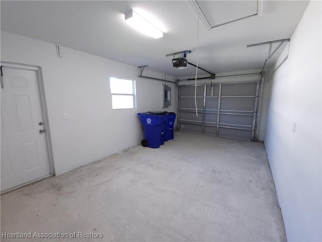 garage featuring electric panel and a garage door opener