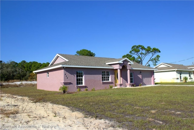 single story home with a garage and a front lawn